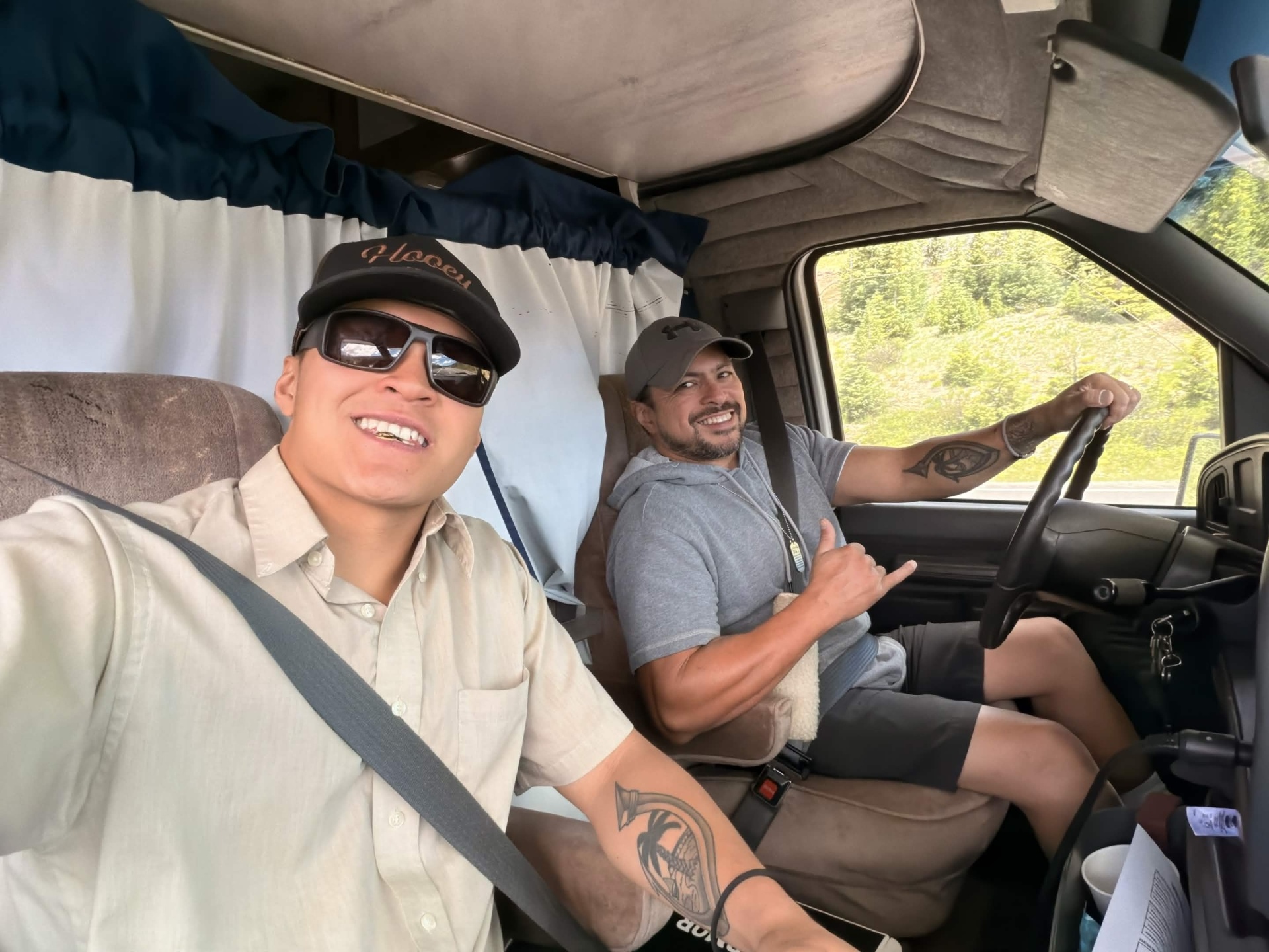 JunkHunksCo team members smiling in the cab of the junk removal truck
